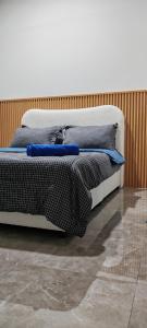 a bed with two pillows on it in a room at Amyza Homestay 3Bilik in Semerah +4 photos