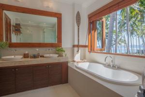 a bathroom with two sinks and a large mirror at Villa Anjani - Ocean view Villa, With Private Garden and Cook - Candidasa in Candidasa