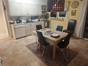 a kitchen with a dining room table and chairs at Malmoxie Unic Garden House in Oxie