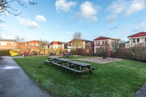 a park with a picnic table and a playground at Malmoxie Unic Garden House in Oxie