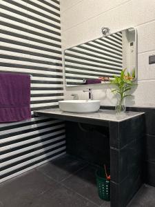 a bathroom with a sink and a mirror at The Regent Villa in Unawatuna