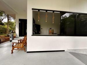 a living room with a large window and a chair at The Regent Villa in Unawatuna