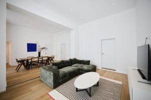a living room with a couch and a table at Toison d'Or & saunna 2 in Brussels