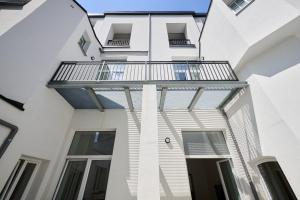 an external view of a white building with a balcony at Toison d'Or & saunna 2 in Brussels