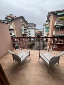 a balcony with two benches and some buildings at Rustic Apartment with AC in Bergamo