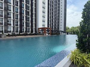 a large swimming pool in front of two tall buildings at Self Check in at Classy 3BR Kajang in Kajang