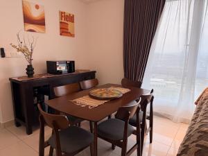 a dining room table and chairs in a room with a desk at Self Check in at Classy 3BR Kajang in Kajang