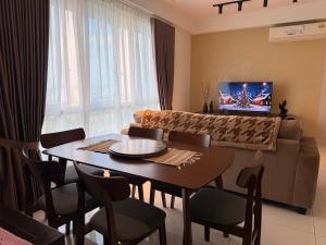 a living room with a table and a couch at Self Check in at Classy 3BR Kajang in Kajang