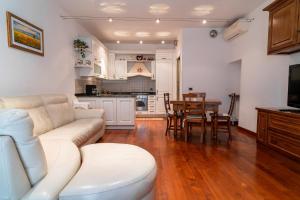 a living room with a white couch and a table at Barsotti House - Lucca in Lucca