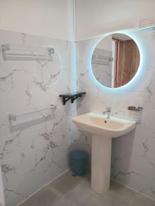 a bathroom with a sink and a mirror at Inuli Coco Hut in Kalutara