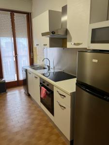 a kitchen with a stove and a refrigerator at Rustic Apartment with AC in Bergamo