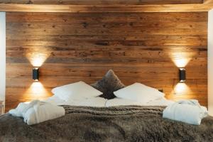 a bedroom with a bed with two lights on it at Hotel Matterhornblick in Zermatt