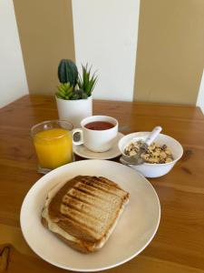 a table with a plate of toast and a bowl of nuts at Hotel Terra Iquique in Iquique