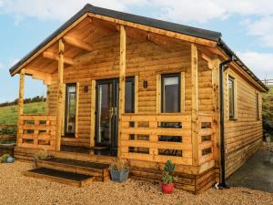 a log cabin with a porch at Glenview Log Cabin in Ballycastle