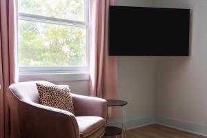 a living room with a chair and a window at Kasa Edison House South End Dilworth Charlotte in Charlotte