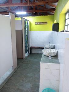 a bathroom with a counter and a yellow wall at Sirimon Base Camp in Nanyuki