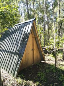 a small wooden shed with a metal roof at Sirimon Base Camp in Nanyuki