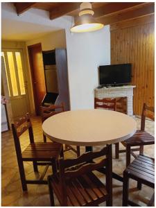 een eetkamer met een tafel en stoelen en een open haard bij PH Santa Teresita in Santa Teresita