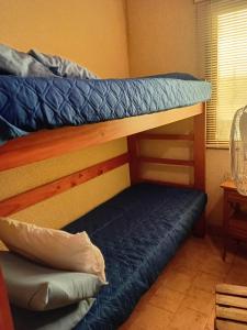 2 stapelbedden in een kamer met een blauw matras bij PH Santa Teresita in Santa Teresita