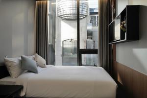 a bedroom with a large bed and a large window at Stay Ohana in Seoul