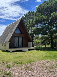 a small house with a gambrel roof at Cabana Itapeva Torres in Torres