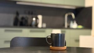 een koffiekopje op een tafel in een keuken bij NEW STYLISH APARTMENT Varta Alpha 2025 & Parking in Praag
