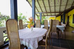 a dining room with a table and chairs at Solomon Beach Hotel in Marawila