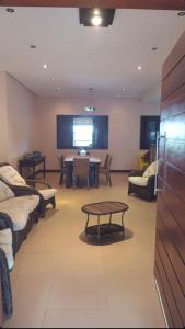 a living room with a table and a large screen at Sítio flor do campo 7L in Sete Lagoas +2 photos