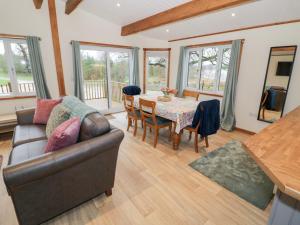 a living room with a couch and a table at Cedar Lodge in Rugeley