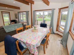 a dining room with a table and chairs at Cedar Lodge in Rugeley +11 photos