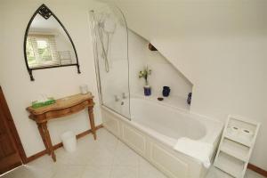 a bathroom with a bath tub and a sink at 4 Bed in Penmaen oc-hh86 in Nicholaston +31 photos