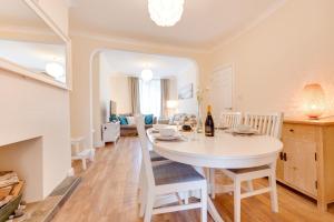 a kitchen and living room with a white table and chairs at 3 Bed in Mumbles oc-hh668 in The Mumbles +13 photos