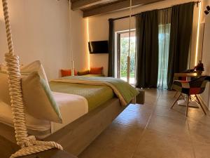 a swinging bed in a room with a window at I SECOLARI in Sannicandro di Bari