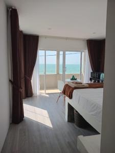 a bedroom with a bed and a view of the ocean at Inuli Coco Hut in Kalutara +58 photos