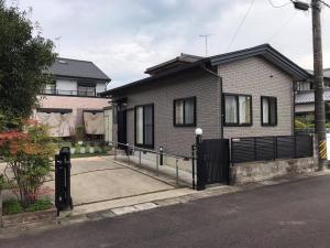 a house with a black fence in front of it at PhaseSpace in Sekimachi
