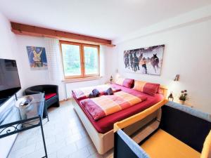 a bedroom with a large bed and a television at Apartment Curtins18 by Interhome in Pontresina +17 photos