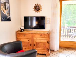 a living room with a television on a wooden dresser at Apartment Curtins18 by Interhome in Pontresina