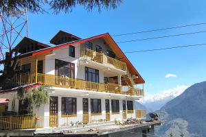 a large building with a view of the mountains at Rana Ridges in Banjār