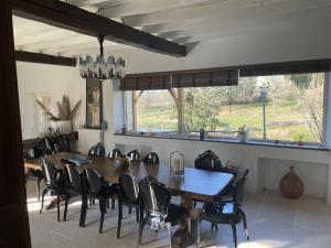 a dining room with a large wooden table and chairs at La Bastide in Armous-et-Cau