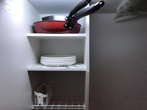 a kitchen with plates and a bowl on a shelf at PhaseSpace in Sekimachi