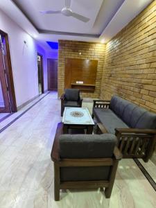 a living room with a couch and a brick wall at Homestay Mohali in Chandigarh Airport +16 photos