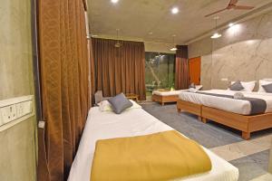 a hotel room with two beds and a room with two beds at Aurobay Resorts Pondicherry in Auroville +101 photos