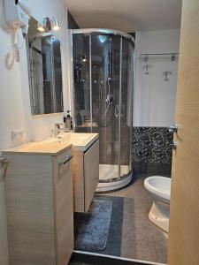 a bathroom with a shower and a sink and a toilet at Casa GiuBarElla in Vanzago