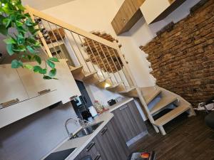 a kitchen with a sink and a staircase in a room at Casa GiuBarElla in Vanzago