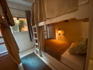 a bedroom with two bunk beds and a window at Jme Bunks Hostel in Aswān +12 photos