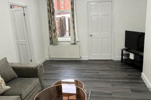 a living room with a couch and a coffee table at 2 Bed Flat - Sleeps 3 - Parking - Wifi in West Boldon