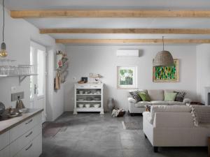 a living room with a couch and a table at Holiday Home mit eigenem Pool by Interhome in Čepljani