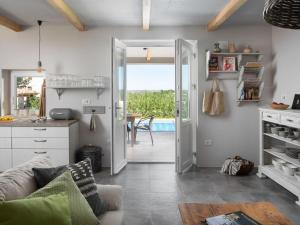 a living room with a door open to a patio at Holiday Home mit eigenem Pool by Interhome in Čepljani