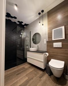 une salle de bains avec toilettes, lavabo et miroir dans l'établissement Studio in Centro Stile Buenos Aires con Check-in Automatico H24 e Parcheggio Gratuito, à Casale Monferrato