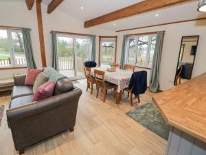 a living room with a couch and a table at Elm Lodge in Rugeley